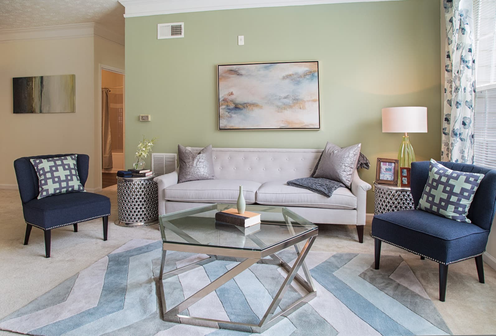 Carpeted living room with green accent wall