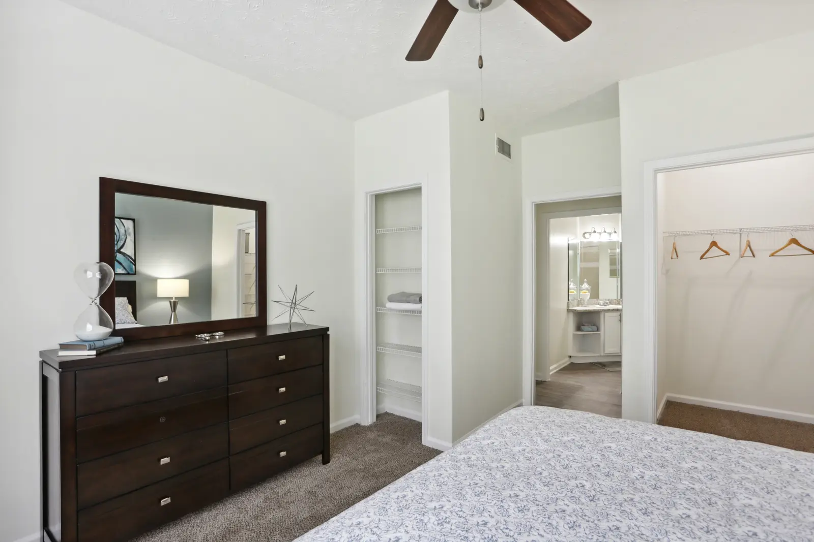 Carpeted bedroom with walk-in closet and linen closet