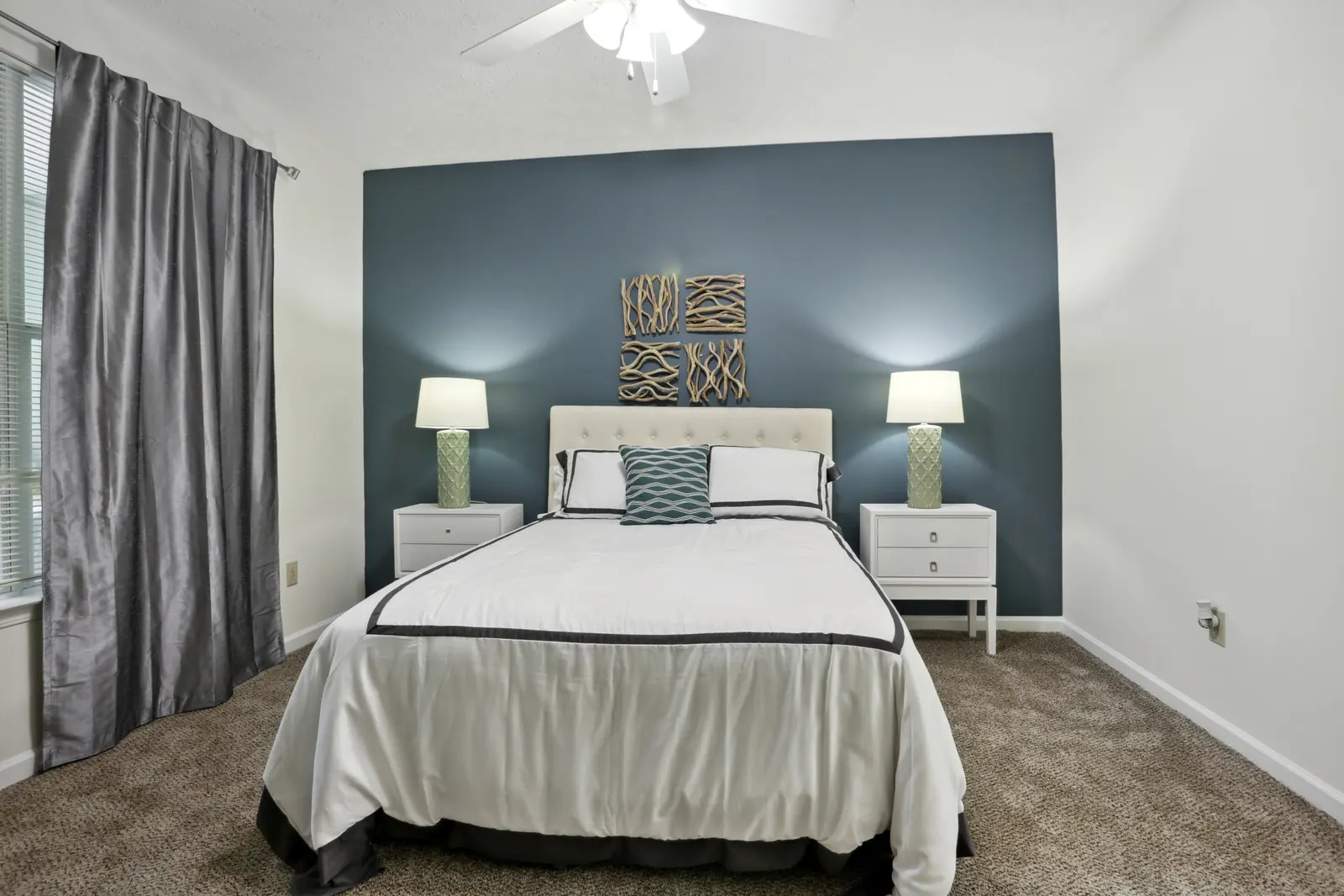 Carpeted bedroom with blue accent wall